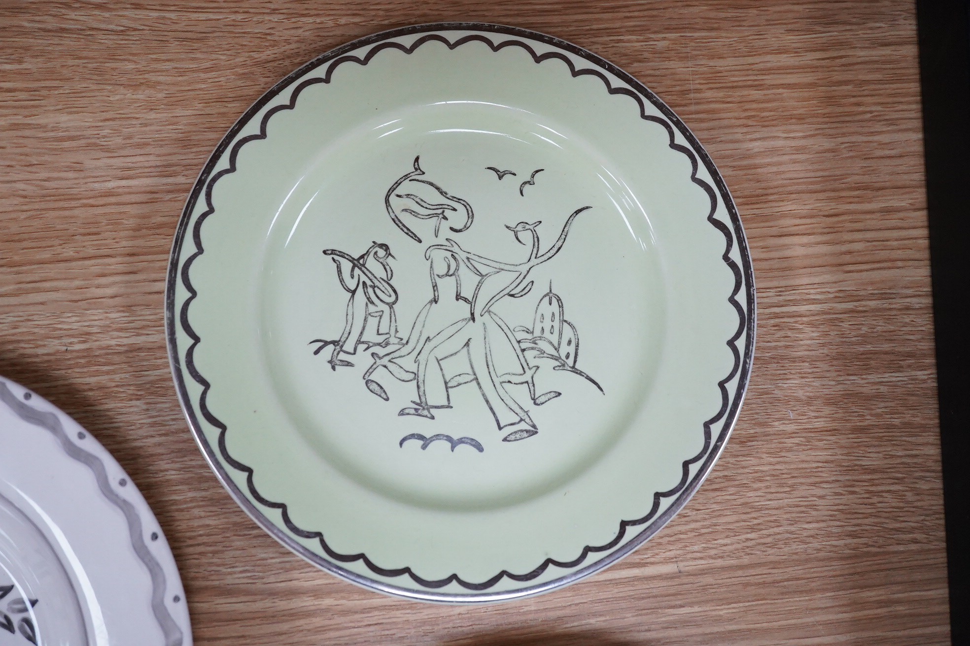 A Billie Waters Clarice Cliff Bizarre bowl, John Armstrong Bizarre bowl and an Ernest Proctor plate, 23cm in diameter